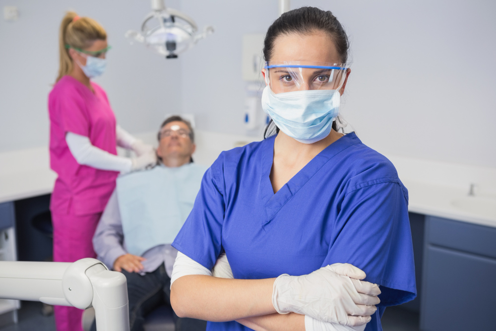 Dental professional wearing protective gear in clinic, symbolizing skill assessments and recruitment for healthcare and dental positions.