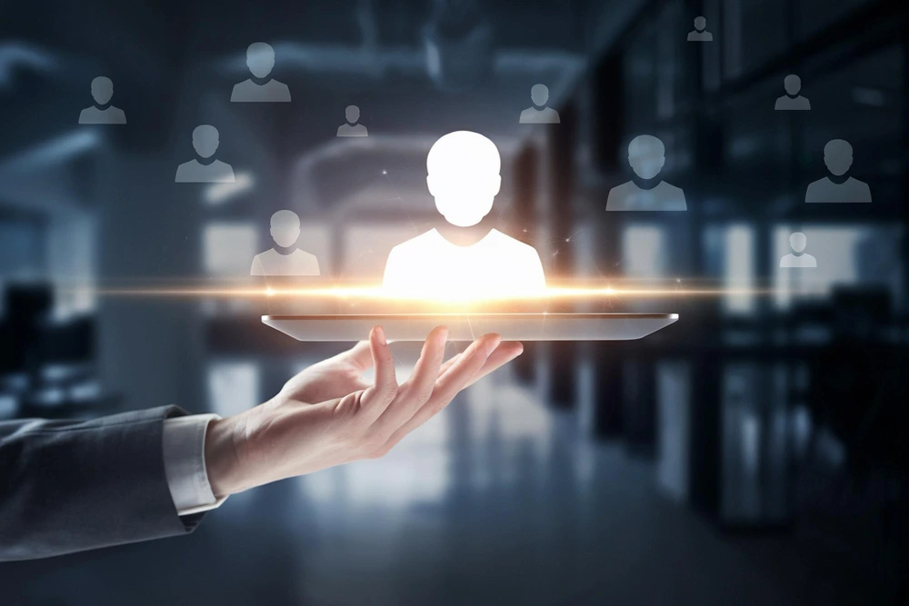 Executive search talent selection visual showing a glowing candidate icon floating above a hand with multiple applicant silhouettes in the background.